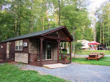 cabin with porch and stone